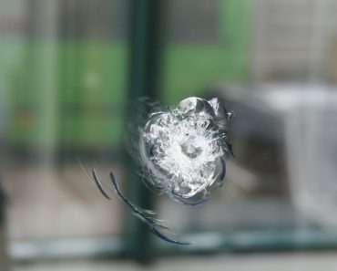 A round trace of bullets coming into the thick window glass(kamienczanka)s