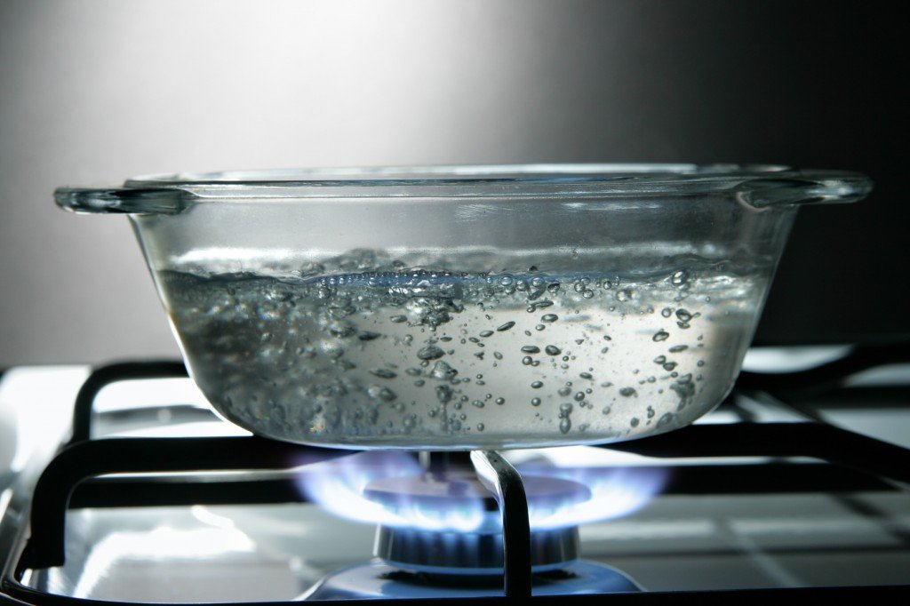 Boiling water in glass saucepan