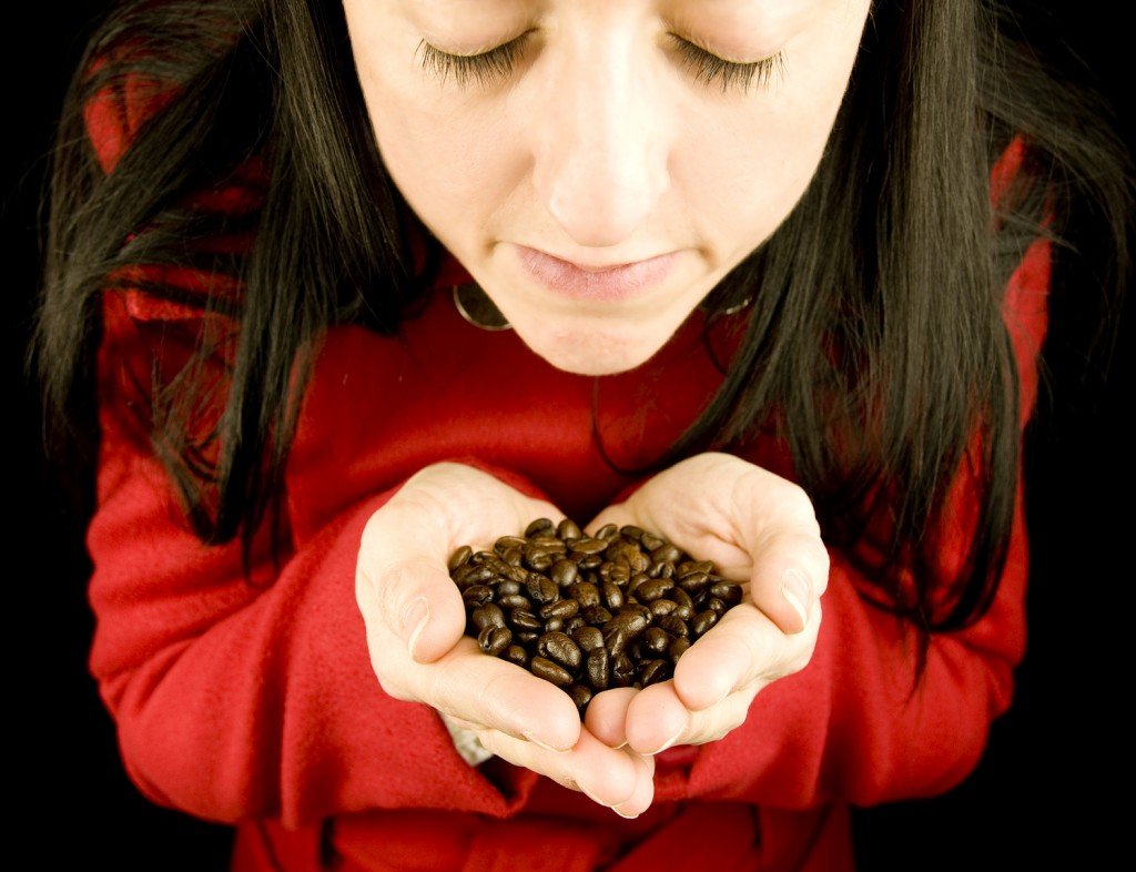 girl smelling coffee beans