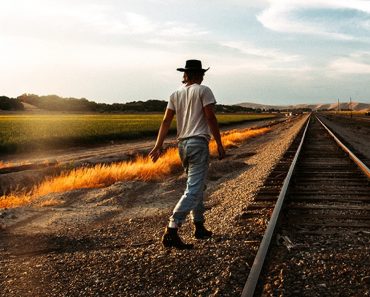 Man walking near railway track