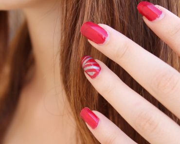 Hand red nail polish
