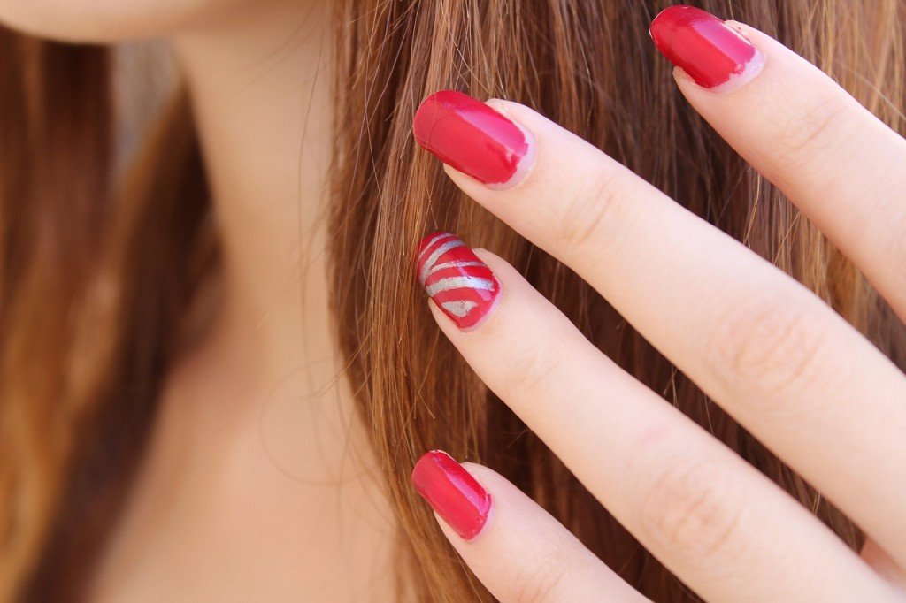 Hand red nail polish