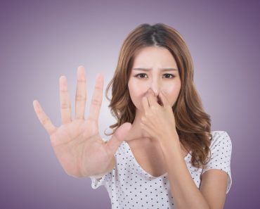Portrait of a young woman holding her nose because of a linger bad smell girl. (elwynn)(s)