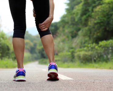 young fitness woman jogger hold her sports injured leg at forest trail (lzf)(s)