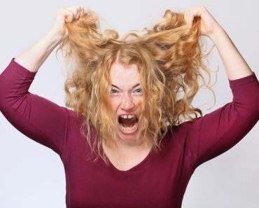 Woman Pulling Out frizz Hair