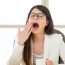 Yawning woman in office