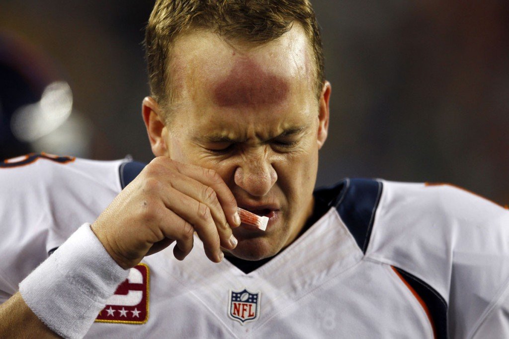 Denver Broncos quarterback Peyton Manning sniffs smelling salts