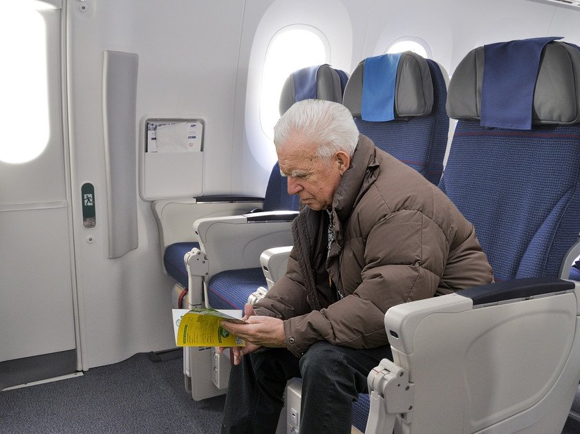 Old man sitting in airplane