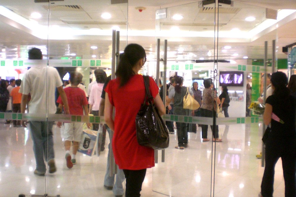 Woman entering in the shopping mall entrance