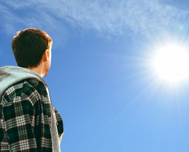 Young man looking at sun