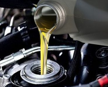 Pouring motor oil in engine