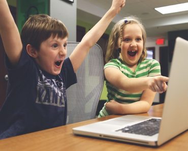 children playing video game computer laptop