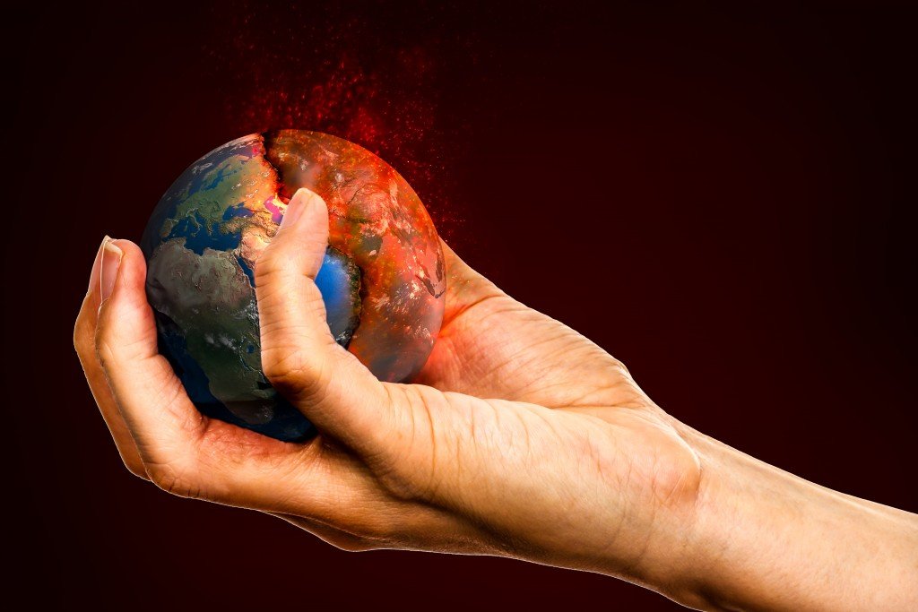 Ecology concept, holding the Earth in hands destroying it Elements of this image furnished by NASA Image (Adisorn Saovadee)