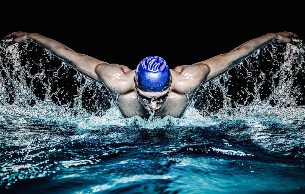 Muscular young man in blue cap in swimming pool - Image( Nejron Photo)s