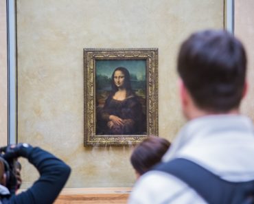 PARIS - AUGUST 4 Visitors take photo of Leonardo DaVinci's Mona Lisa at the Louvre Museum, August 4, 2012 in Paris, France. The painting is one of the world's most famous- Image(S-F)s
