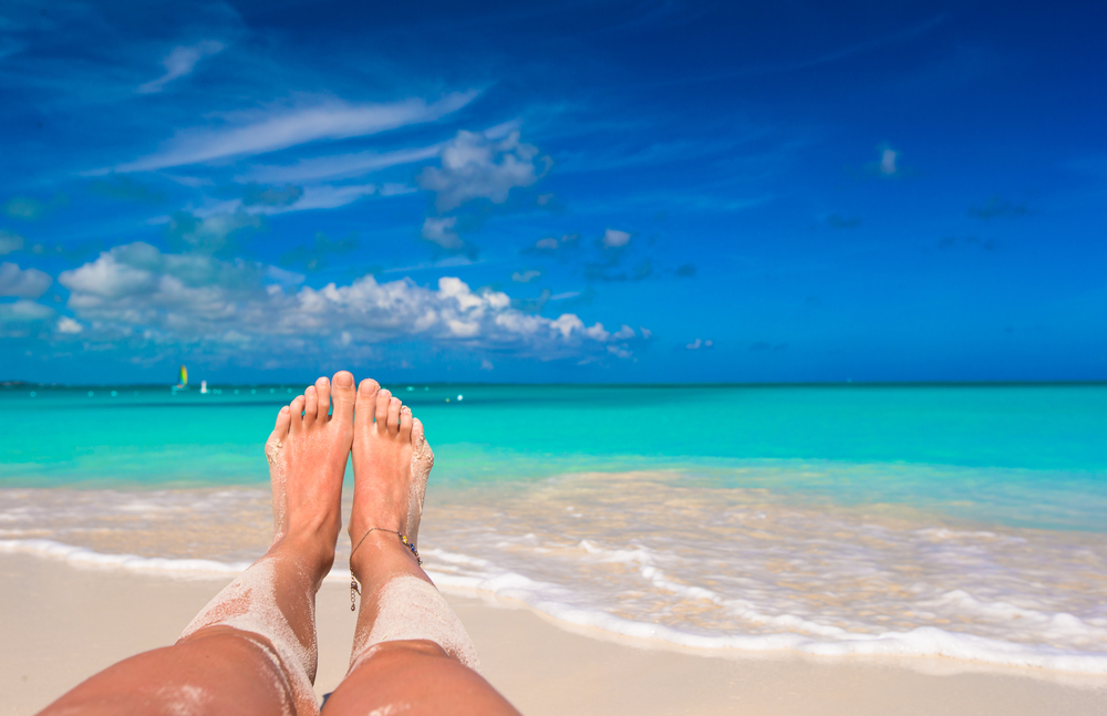 Female feet on white sandy beach - Image(TravnikovStudio)s