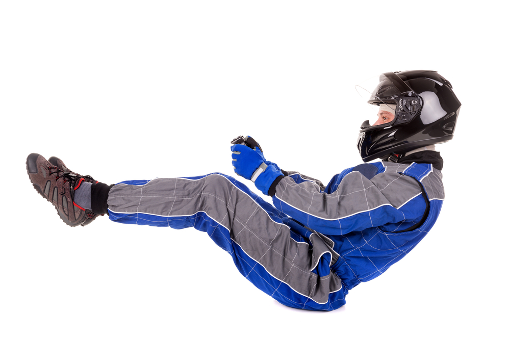 Racing driver posing in driving position in full gear isolated in white(Luis Louro)s