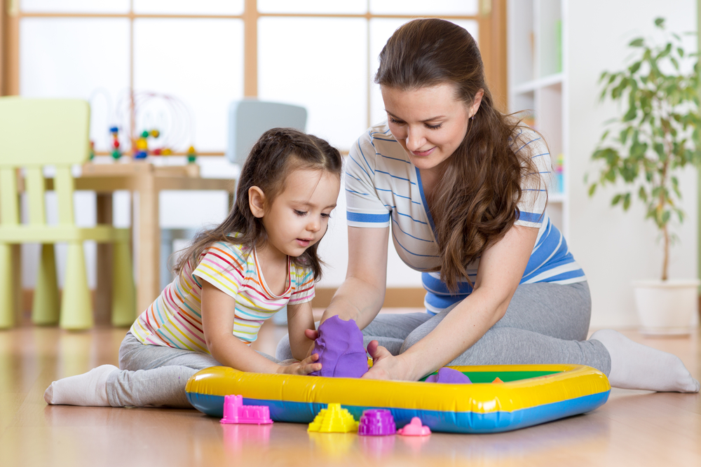 Child girl and mother playing with building toy sand at home - Image( Oksana Kuzmina)S