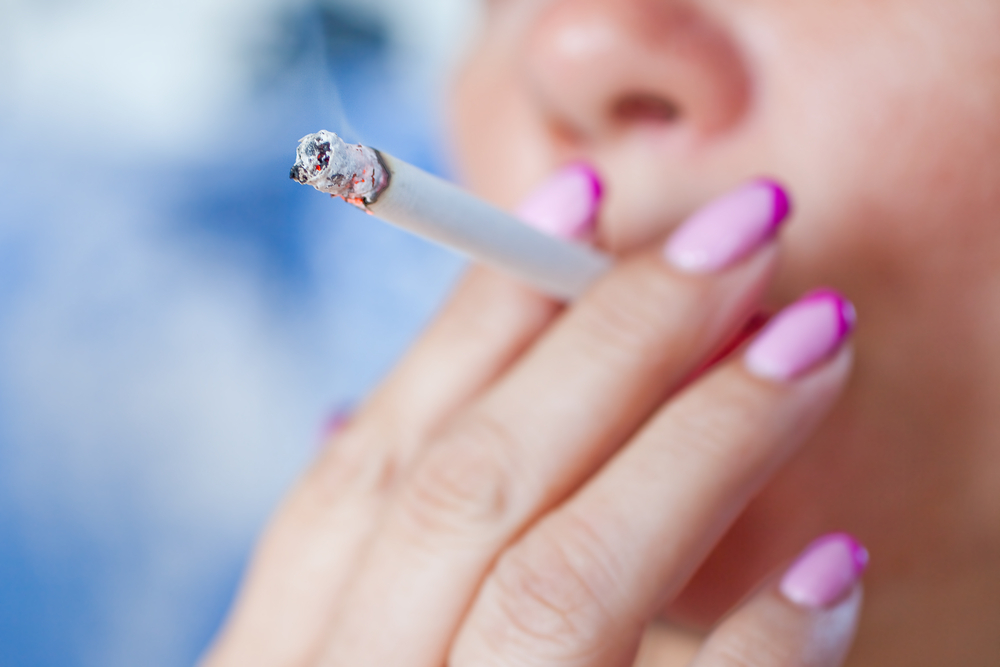 Woman smoking a cigarette. Smoke spread. - Image(Stanislaw Mikulski)s