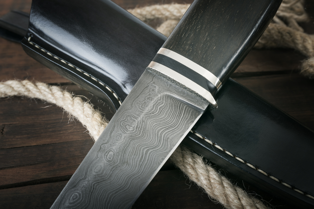 hunting knife handmade on a brown wooden background - Image(ULKASTUDIO)s