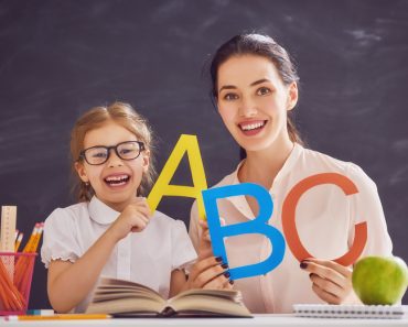 Back to school! Child is learning to write. Adult woman teaches child the alphabet. - Image( Yuganov Konstantin)s