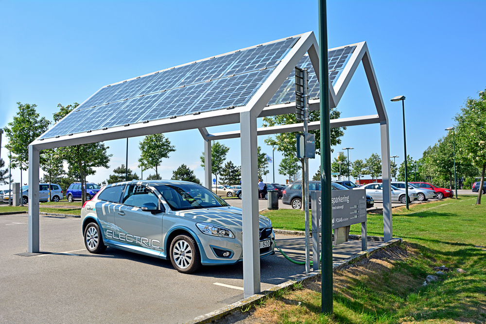 Electric car, part of the car-sharing system, standing at solar powered charge station (photovoltaics)( Martyn Jandula)s