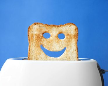 Funny slice of bread with toaster on color background( Pixel-Shot)s