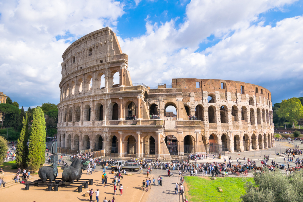 Tourists enjoy a sunny day to visit de fabulous Colosseum one of the 7 Wonders of the Modern World( Nido Huebl)S