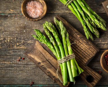 banches of fresh green asparagus on wooden background( Anna Shepulova)S