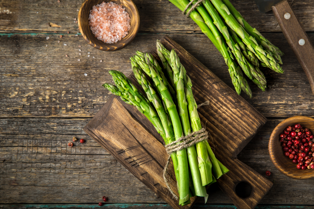 banches of fresh green asparagus on wooden background( Anna Shepulova)S