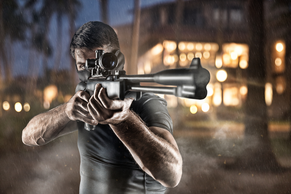 Close-up of man in headgear aiming with sniper rifle(Roka Pics)s