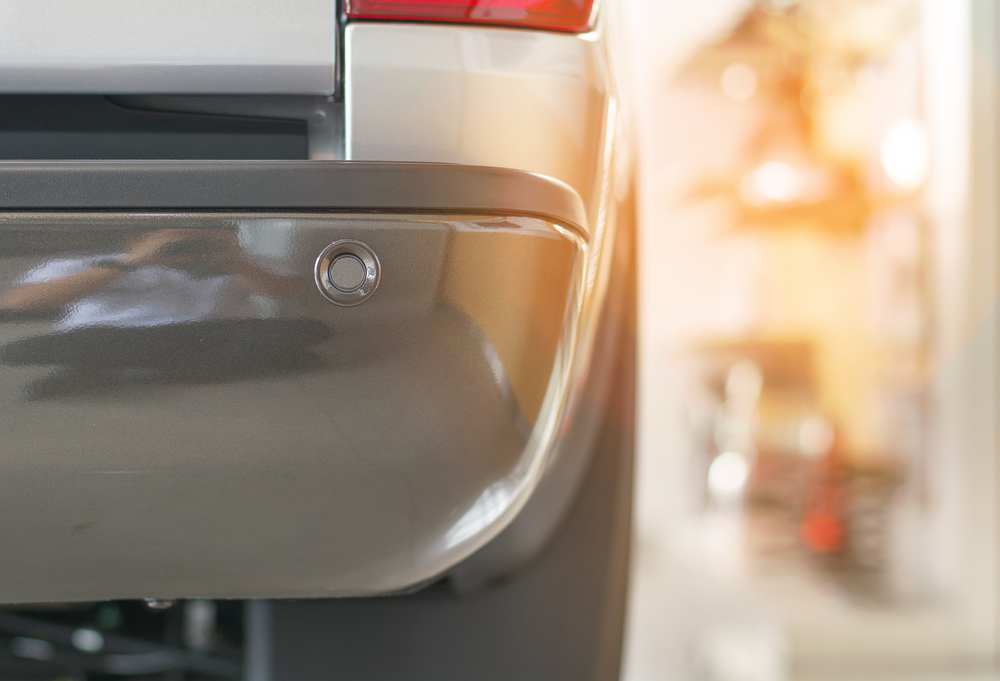 Selective focus parking sensor at rear car bumper on light blurred(CC7)S