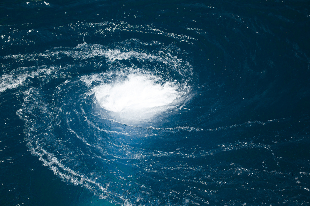 A blue water vortex that funnels below the surface(artcasta)s
