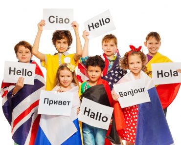 Kids holding greeting signs in different languages(Sergey Novikov)s