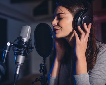 Close up of female vocal artist singing in a recording studio(Jacob Lund)s