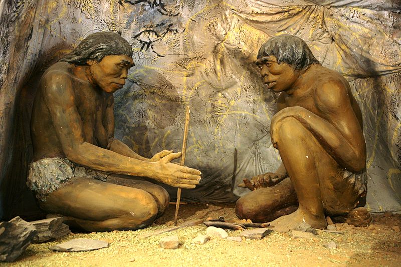 Homo Erectus early human trying to ignite fire