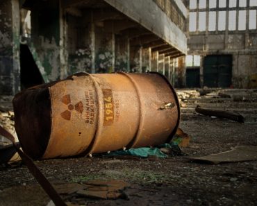 Radioactive warning on old rusty barrel in destroyed and forgotten building(Skorzewiak)s
