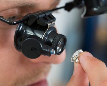Close-up Of Jeweler Looking Ring Through Magnifying Loupe(Andrey_Popov)S