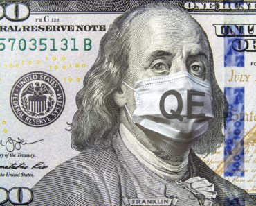 COVID-19 coronavirus in USA, 100 dollar money bill with face mask