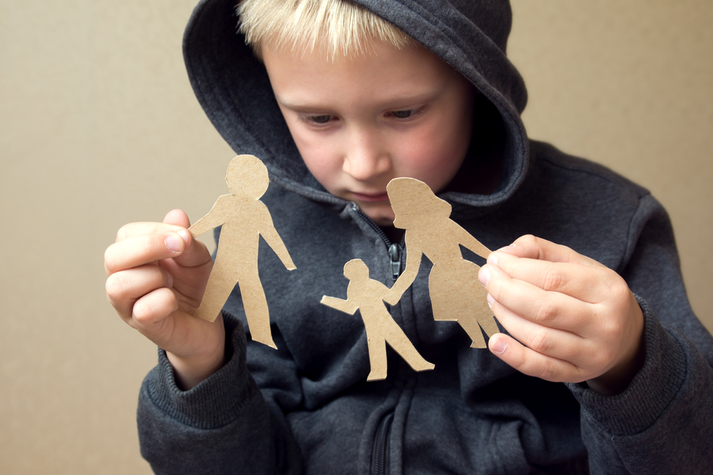 Confused child with broken paper family(Oksana Mizina)