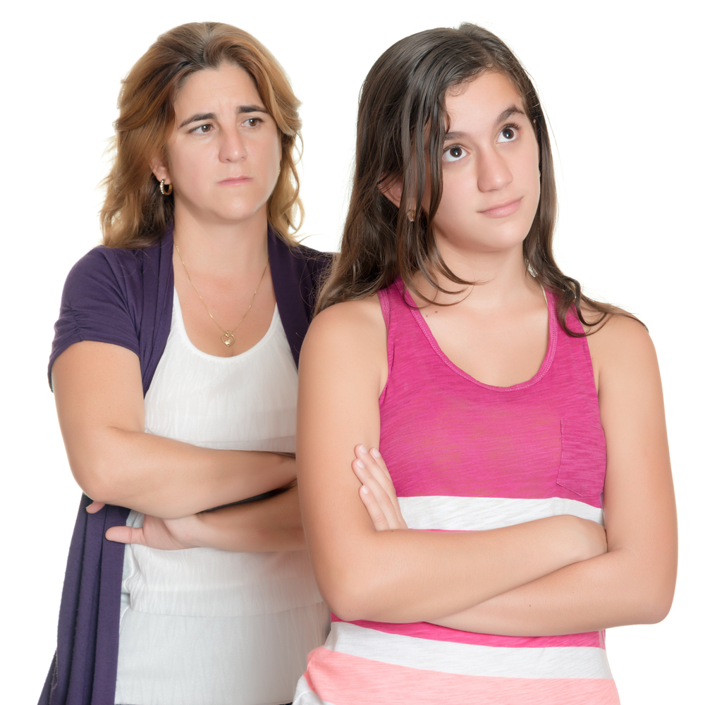 Teenage girl and her sad mother angry at each other isolated on white(Kamira)s