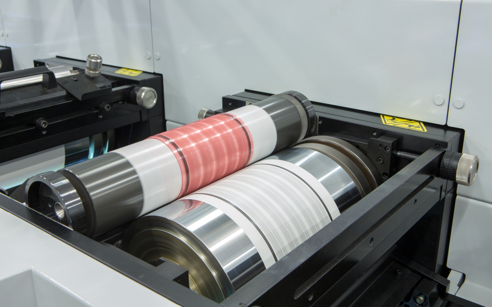 Flexography printing process on in-line press machine. Photopolymer plate stuck on printing cylinder(boitano)s
