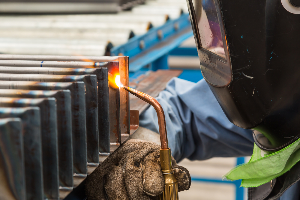 Skill worker performs gas welding on steel workpiece(Matee Nuserm)S