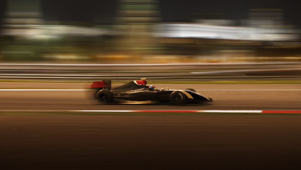 Formula 2.0 race car racing at high speed with motion blur on the background of the city in the dark(Kuznetsov Alexey)s