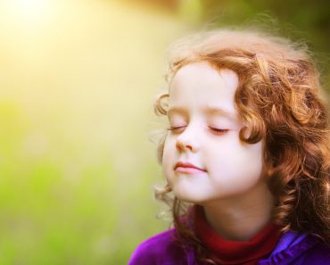 Little girl closed her eyes and breathes the fresh air in the park(Yuliya Evstratenko)S