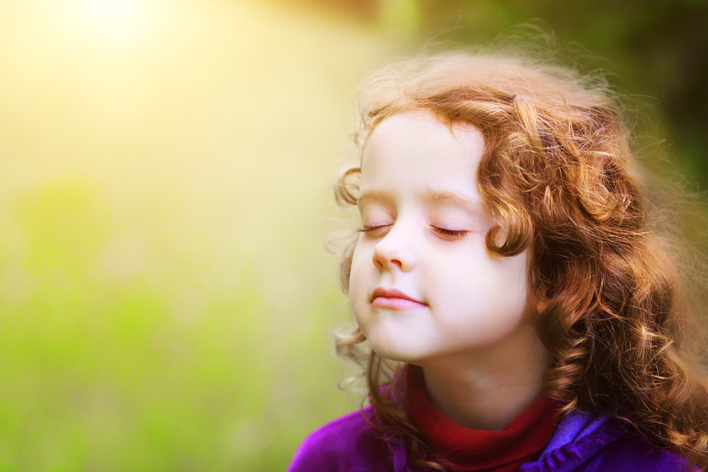 Little girl closed her eyes and breathes the fresh air in the park(Yuliya Evstratenko)S