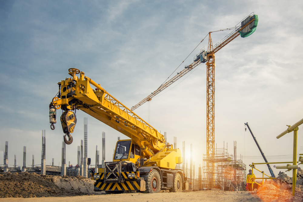 Mobile Crane on a road and tower crane in construction site(Bannafarsai_Stock)s