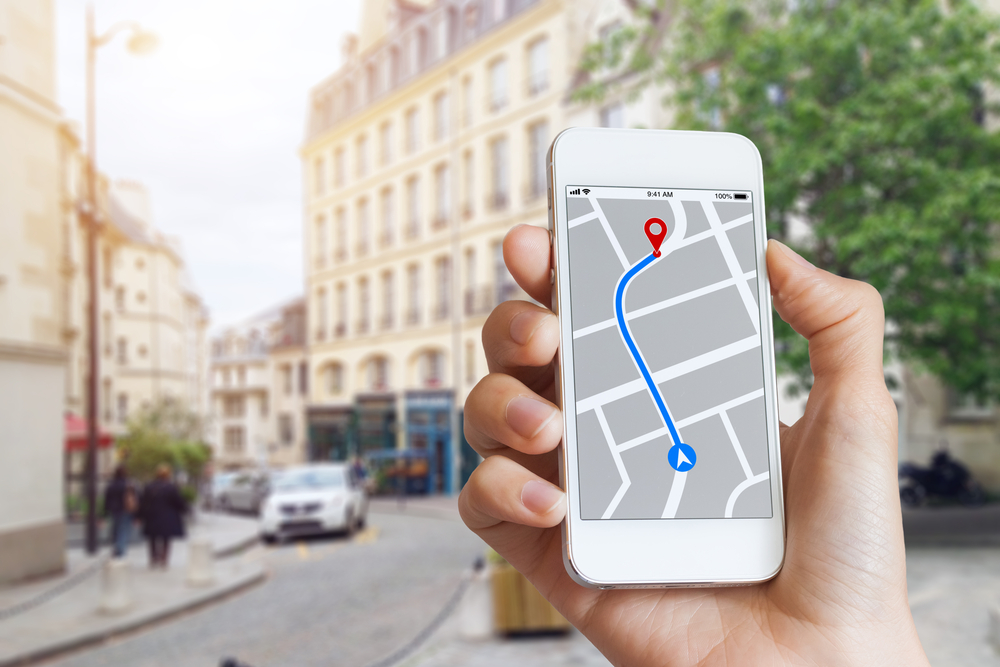 Tourist using GPS map navigation app on smartphone screen to get direction to destination(NicoElNino)s