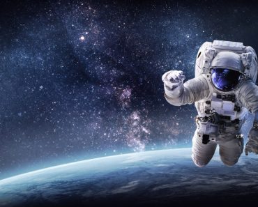 Astronaut in outer space over the planet Earth(Dima Zel)s