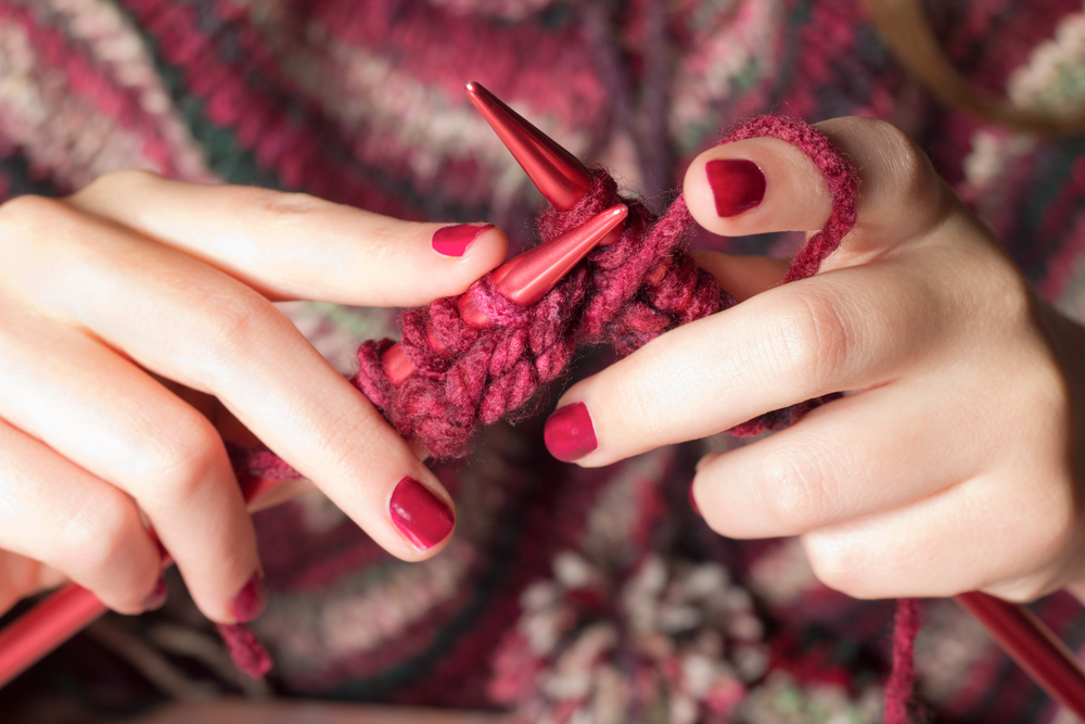 Close-up of hands knitting(littlenySTOCK)s